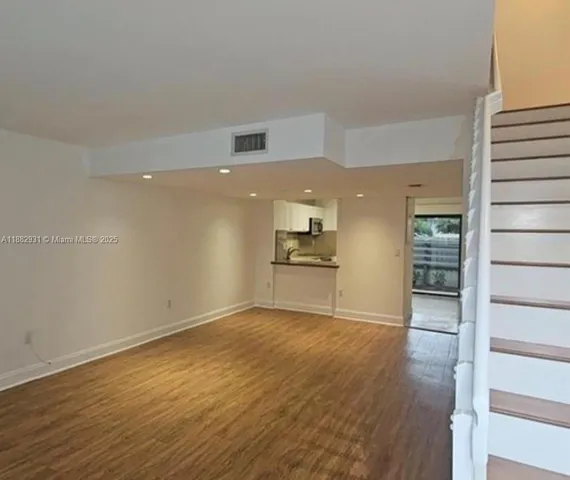 a view of a kitchen with a sink and a refrigerator