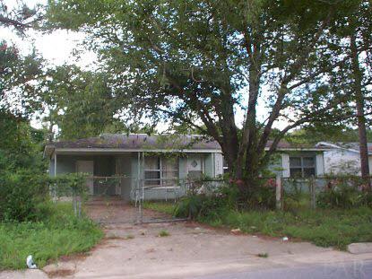 6628 Hampton Road Pensacola, FL 32505 - Photo 1 of 1 a front view of a house with a yard and shrubs