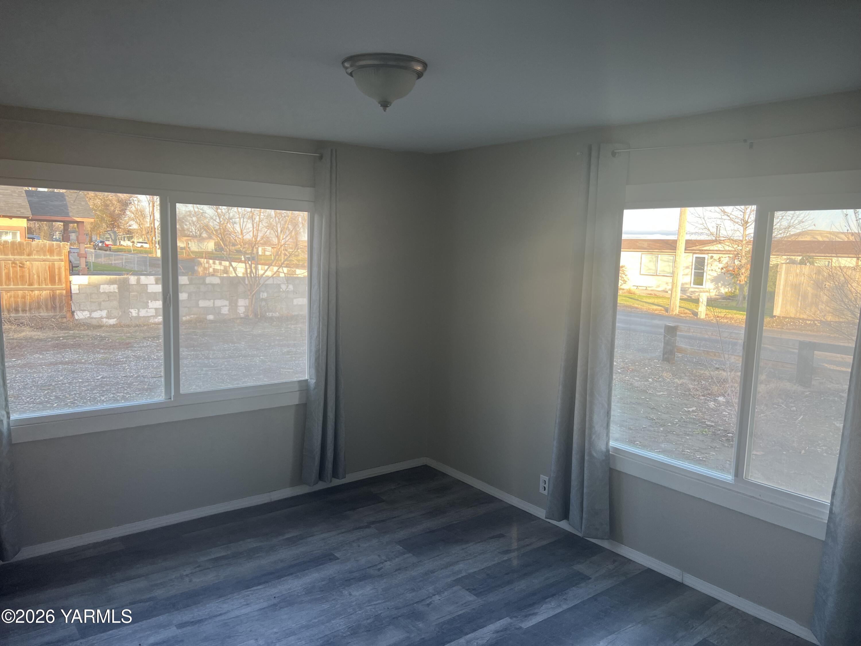 54704 North Evert Road Benton City, WA 99320 - Photo 7 of 21 an empty room with wooden floor and windows