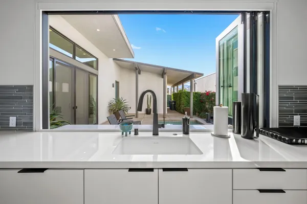 a kitchen with a sink and a large window