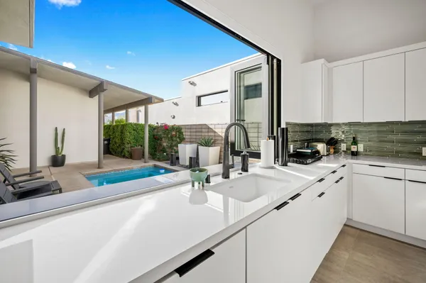 a kitchen with sink refrigerator and cabinets