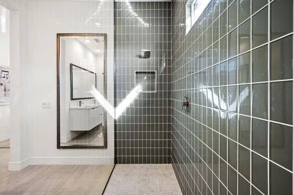a bathroom with a glass door shower and a sink