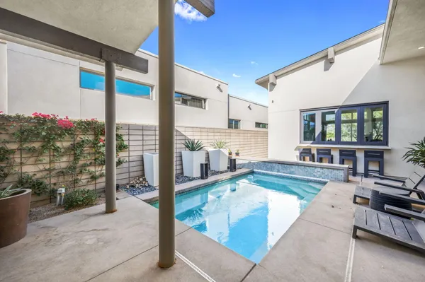 a living room with fireplace furniture and a floor to ceiling window
