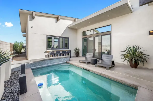 a living room with fireplace furniture and a large window