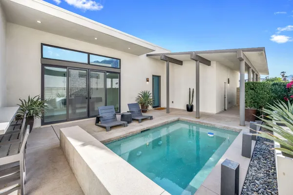 a lobby with furniture and a potted plant
