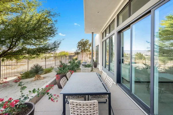 a view of a patio with table and chairs and potted plants