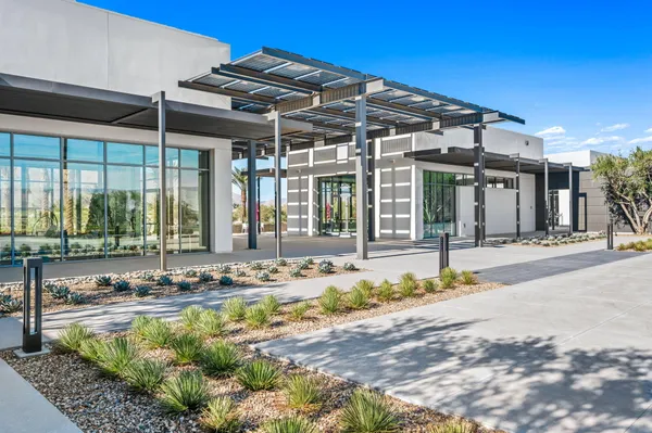 a view of a house with swimming pool and sitting area