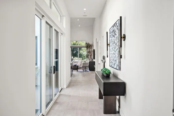 a hallway with a couch and a potted plant