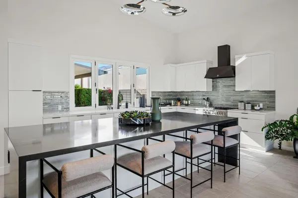 a kitchen with a table chairs stove and cabinets