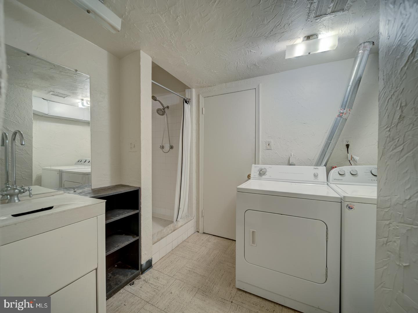 2142 Cathedral Avenue Northwest Washington, DC 20008 - Photo 11 of 60 a utility room with cabinets washer and dryer