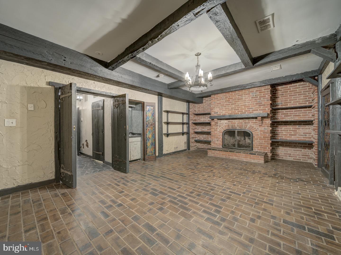 2142 Cathedral Avenue Northwest Washington, DC 20008 - Photo 13 of 60 a view of a livingroom with a fireplace a chandelier and stairs