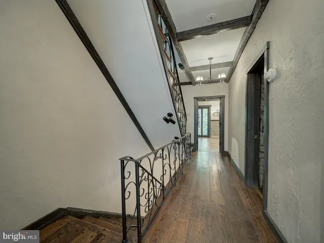 a view of a room with wooden floor and chandelier
