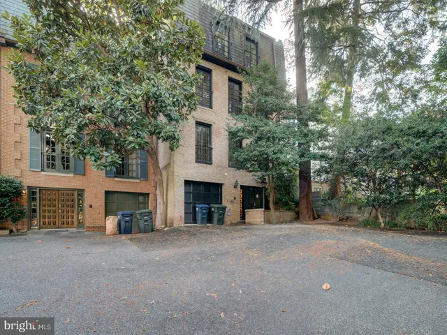 a view of a house with a yard and large tree