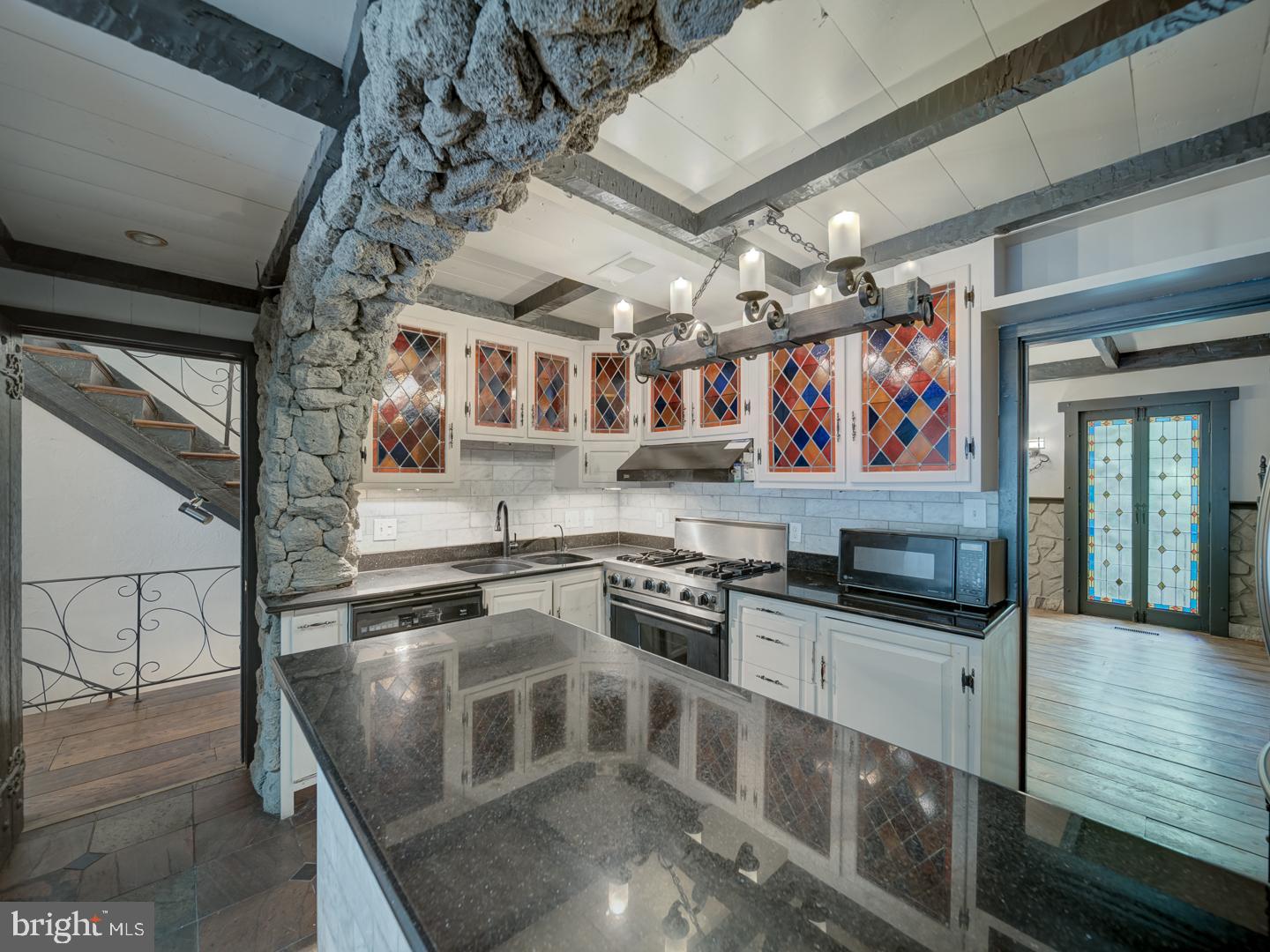 2142 Cathedral Avenue Northwest Washington, DC 20008 - Photo 30 of 60 a kitchen with stainless steel appliances granite countertop a stove and a sink