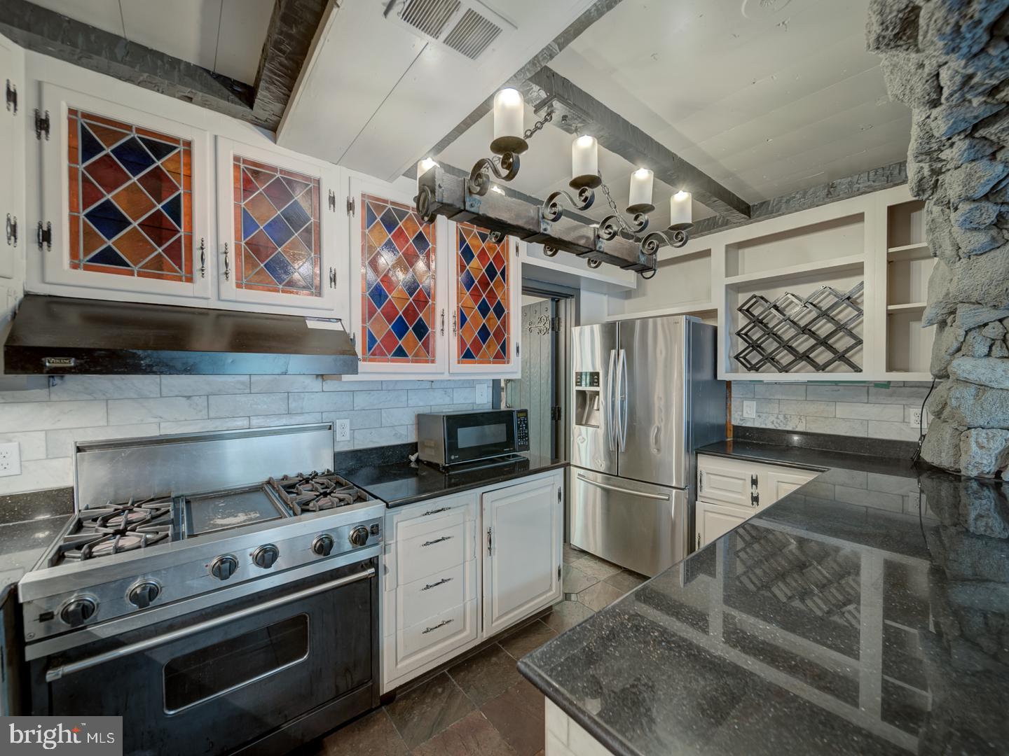 2142 Cathedral Avenue Northwest Washington, DC 20008 - Photo 32 of 60 a kitchen with stainless steel appliances granite countertop a stove and a refrigerator