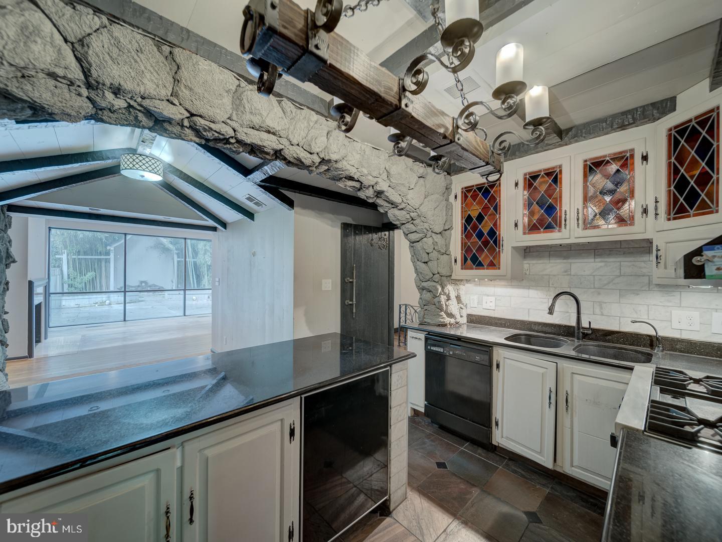2142 Cathedral Avenue Northwest Washington, DC 20008 - Photo 34 of 60 a kitchen with stainless steel appliances granite countertop a sink a stove and cabinets