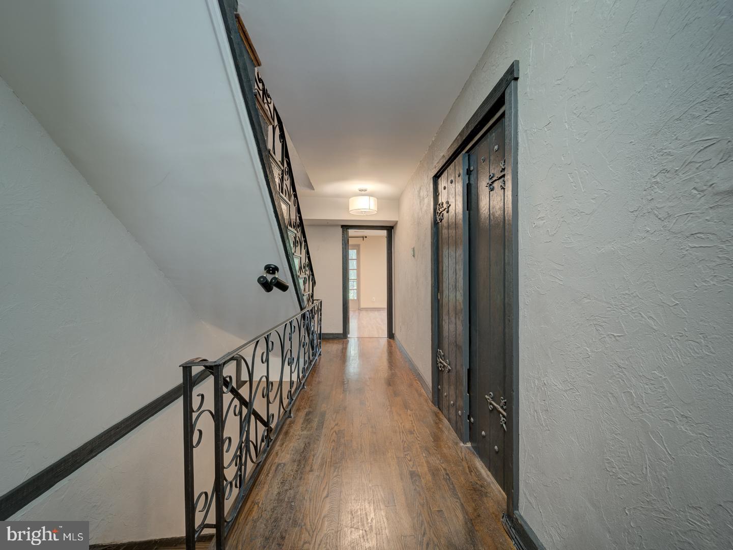 2142 Cathedral Avenue Northwest Washington, DC 20008 - Photo 35 of 60 a view of a hallway with wooden floor and staircase