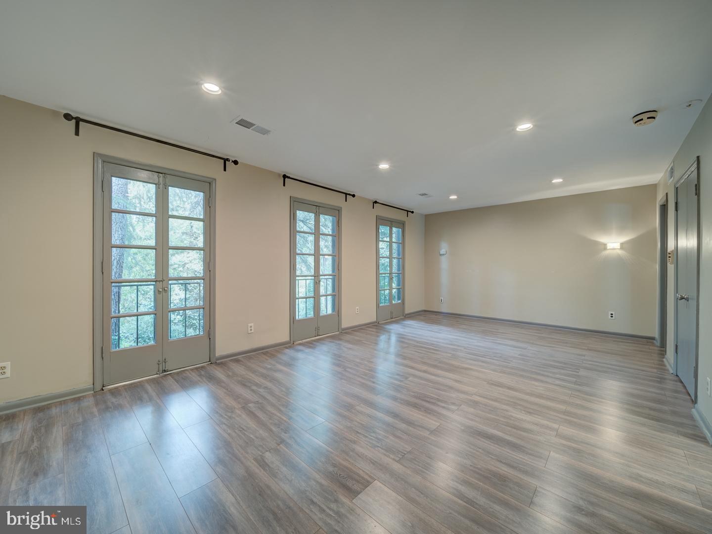 2142 Cathedral Avenue Northwest Washington, DC 20008 - Photo 36 of 60 a view of an empty room with wooden floor and windows