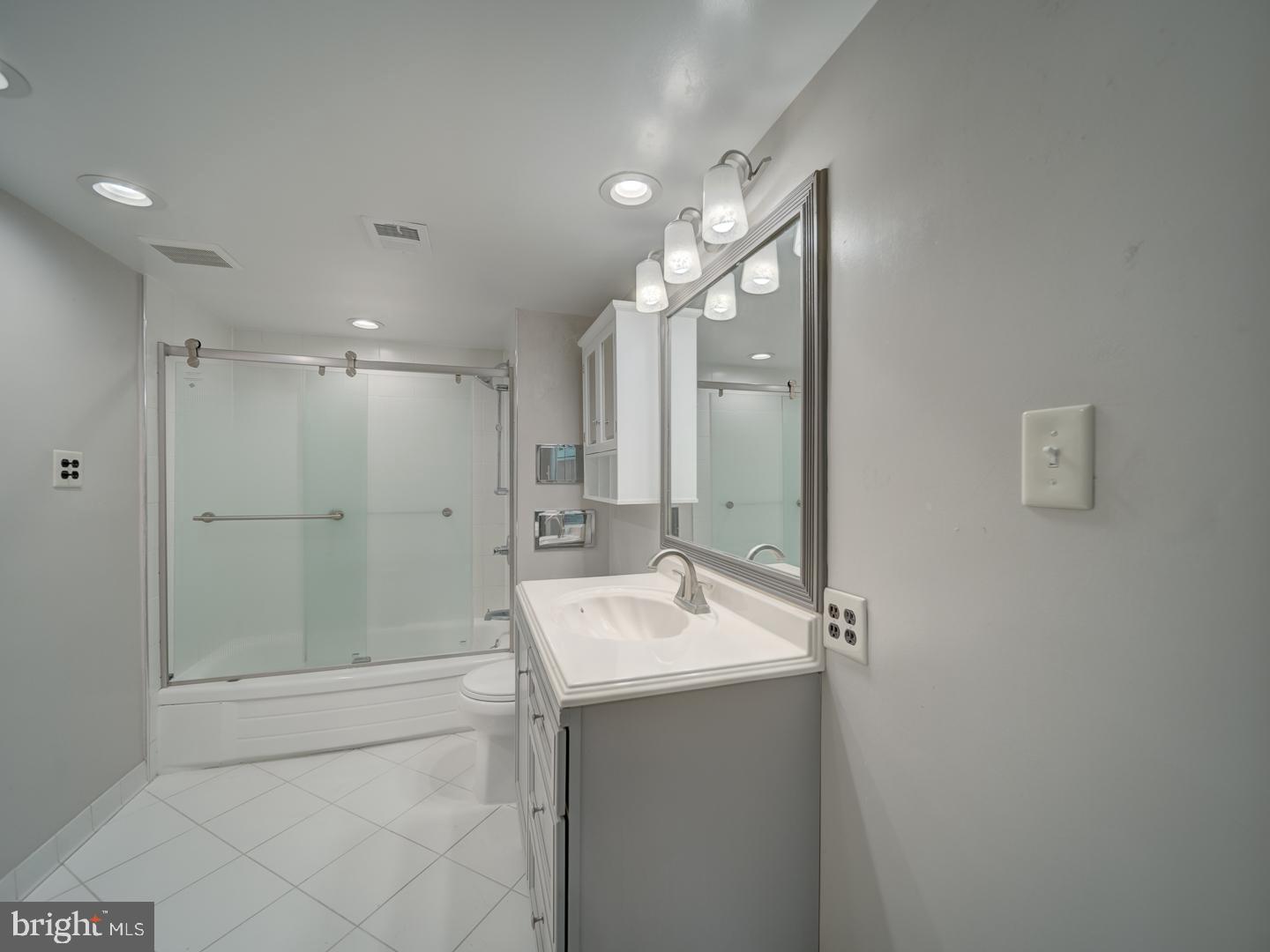 2142 Cathedral Avenue Northwest Washington, DC 20008 - Photo 39 of 60 a bathroom with a shower sink and mirror