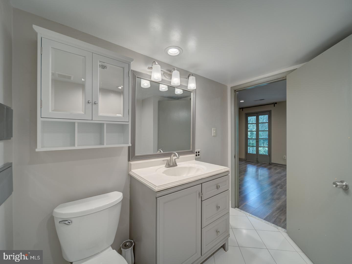 2142 Cathedral Avenue Northwest Washington, DC 20008 - Photo 41 of 60 a bathroom with a toilet sink and mirror