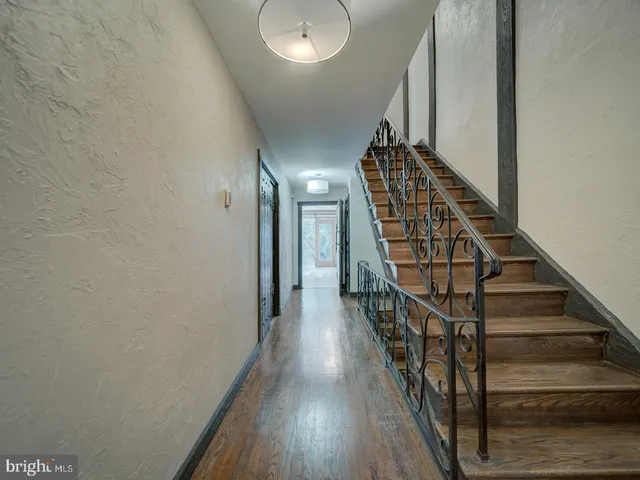 a bathroom with a granite countertop sink mirror and cabinets