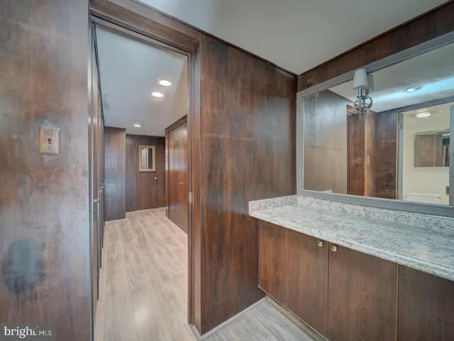 a view of a hallway with wooden shelves