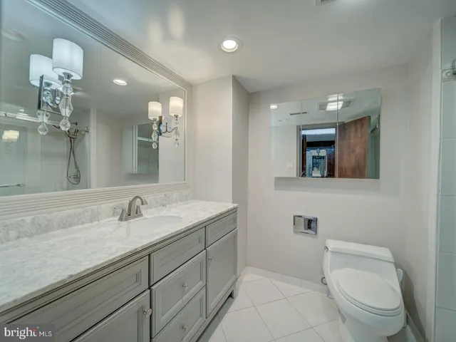 a kitchen with white cabinets and refrigerator