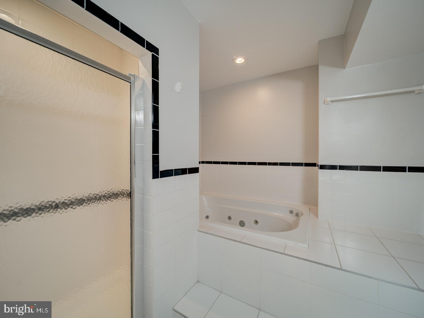 2142 Cathedral Avenue Northwest Washington, DC 20008 - Photo 59 of 60 a bathroom with a glass shower door