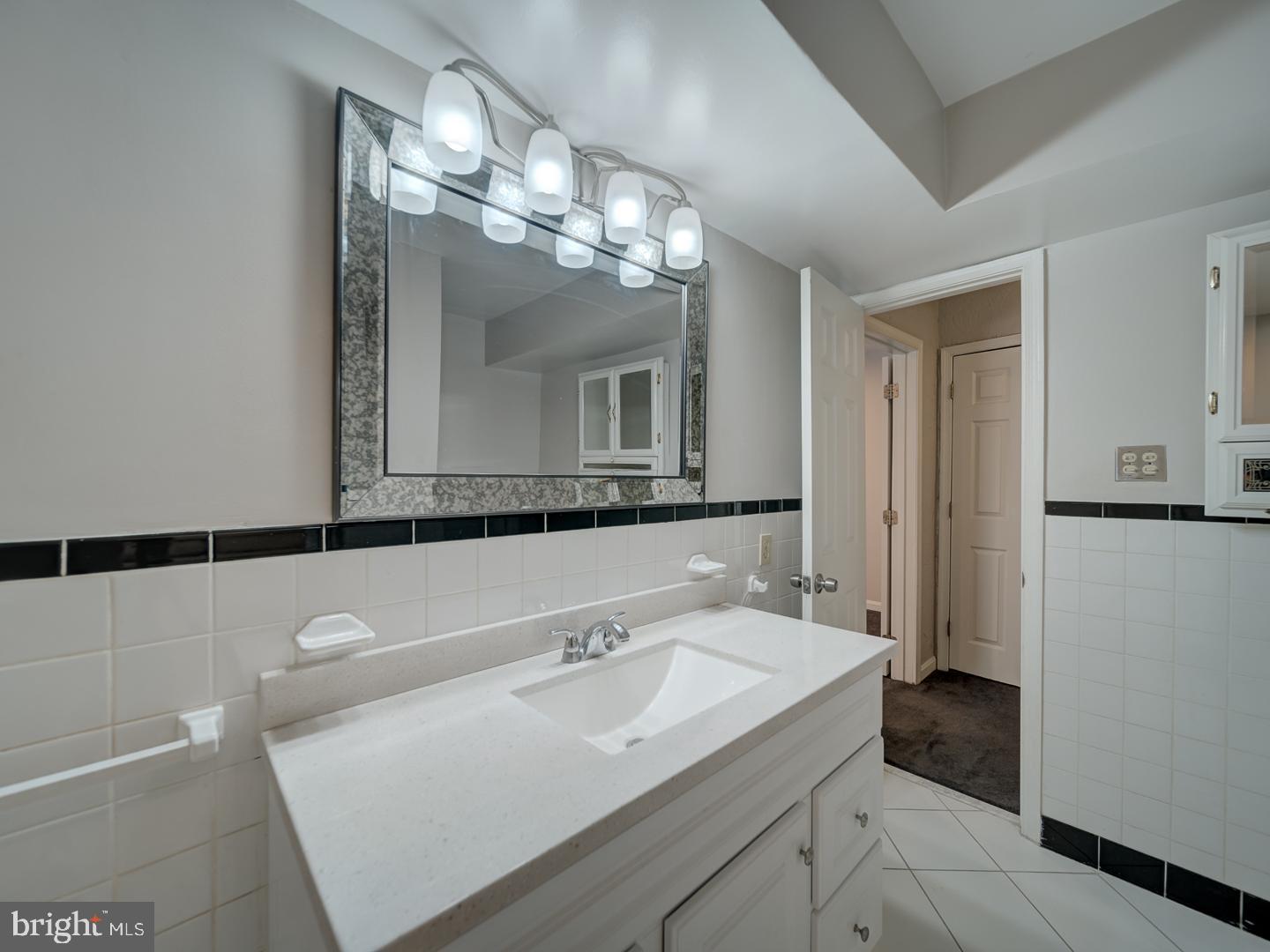 2142 Cathedral Avenue Northwest Washington, DC 20008 - Photo 60 of 60 a bathroom with a sink and a mirror