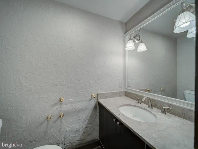 a view of a livingroom with a fireplace a chandelier and stairs