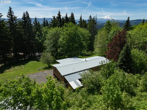 an aerial view of a house with a yard and trees