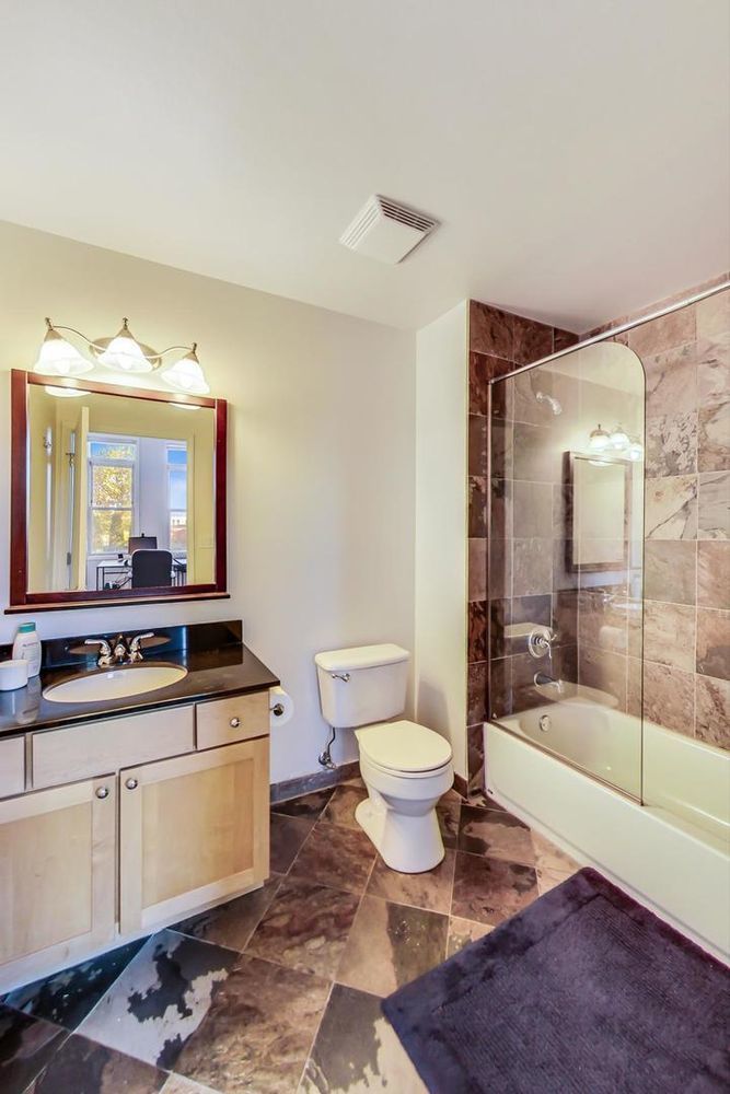 Undisclosed Address Chicago, IL 60610 - Photo 3 of 23 a spacious bathroom with a bathtub shower sink mirror and toilet