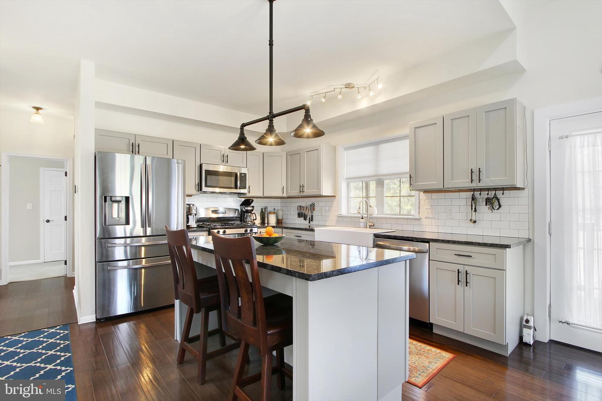 971 McGlaughlin Road Fairfield, PA 17320 - Photo 9 of 57 a kitchen with white cabinets and stainless steel appliances
