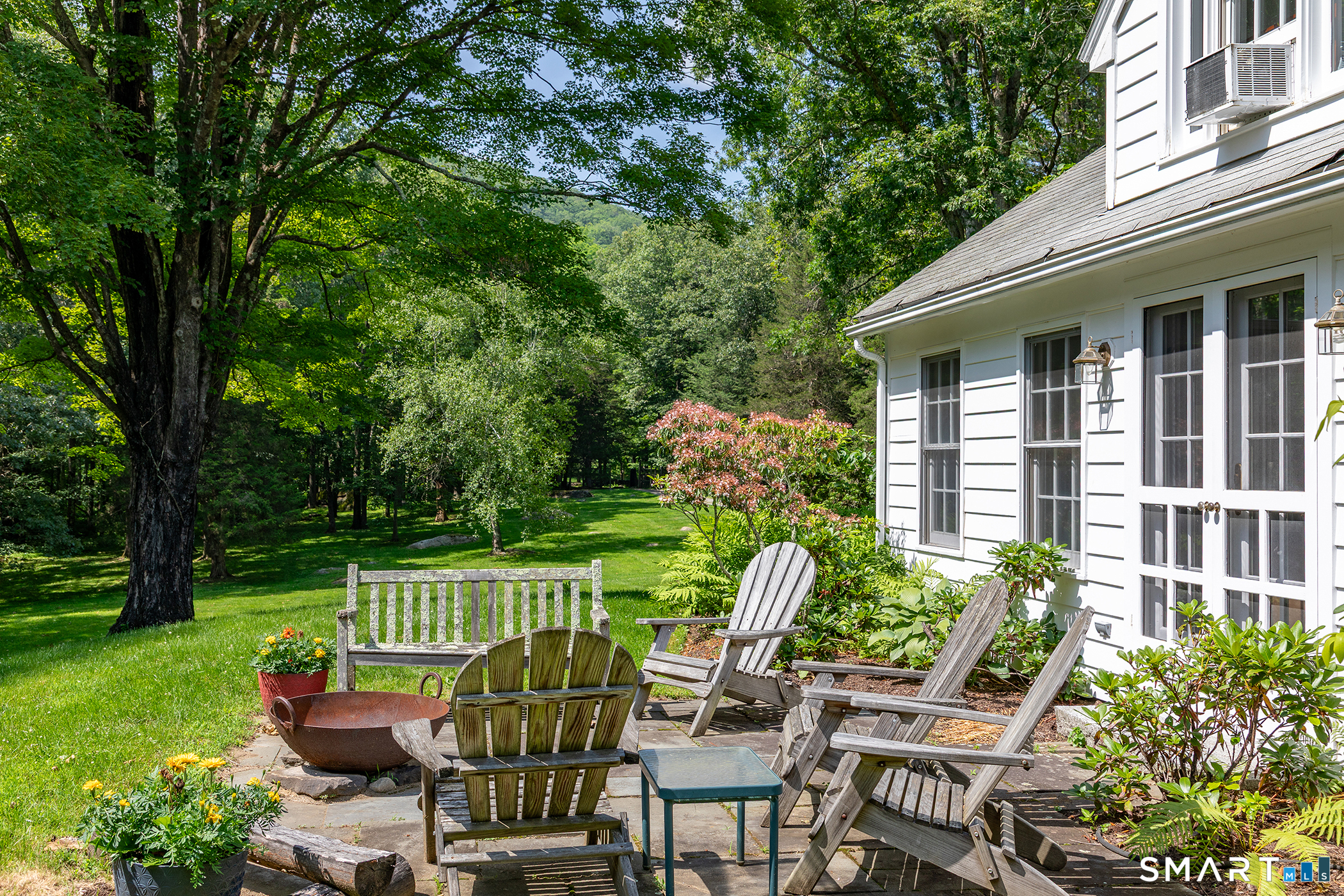 40 Camps Flat Road Kent, CT 06785 - Photo 4 of 5 a view of a chair and tables in the backyard