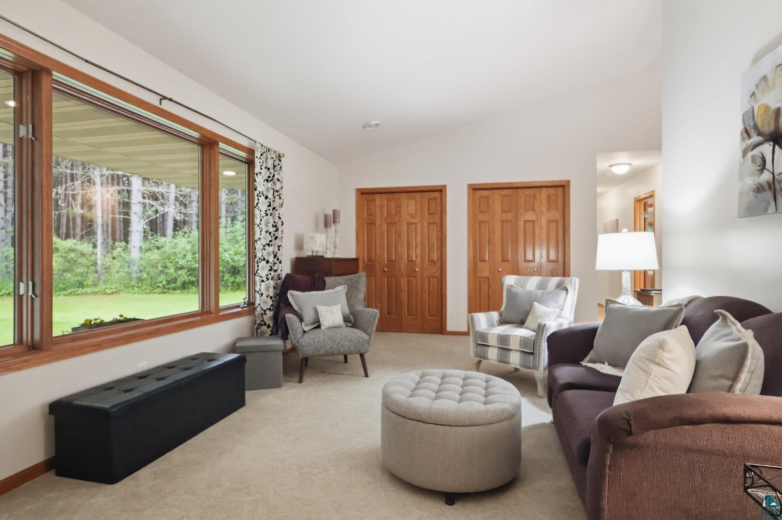 41 East Stark Road Esko, MN 55733 - Photo 4 of 19 Living area featuring a vaulted ceiling and a large picture window with wood trim