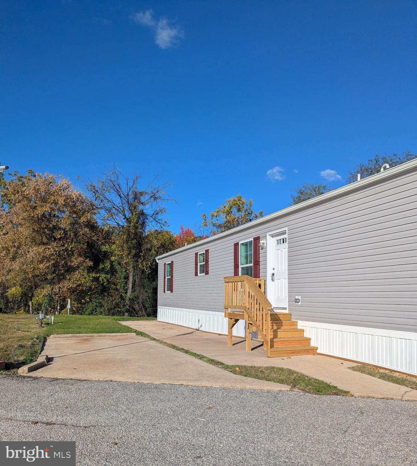 a view of a white house with a yard and garage