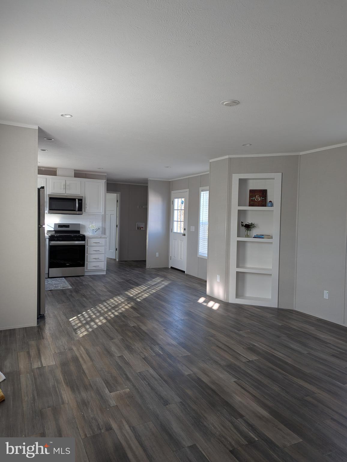 462 Mirabile Lane Baltimore, MD 21224 - Photo 6 of 12 a view of empty room with kitchen and window