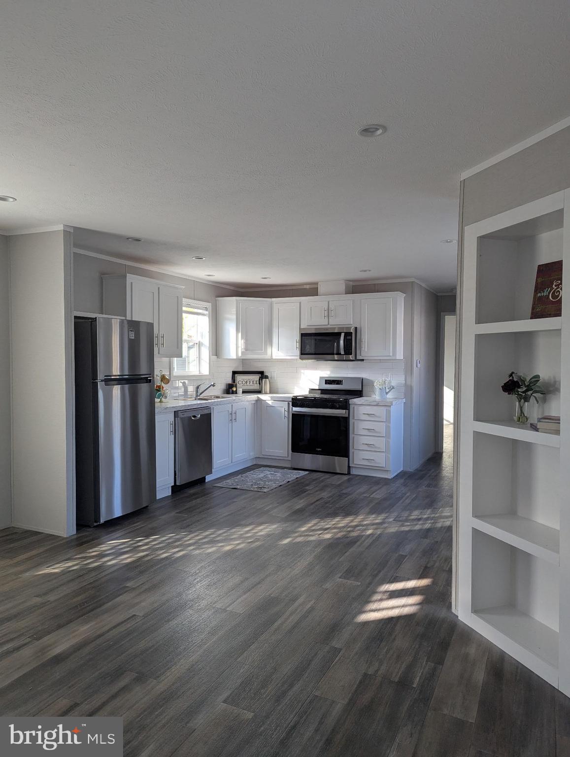 462 Mirabile Lane Baltimore, MD 21224 - Photo 7 of 12 a kitchen with stainless steel appliances granite countertop a refrigerator stove and white cabinets