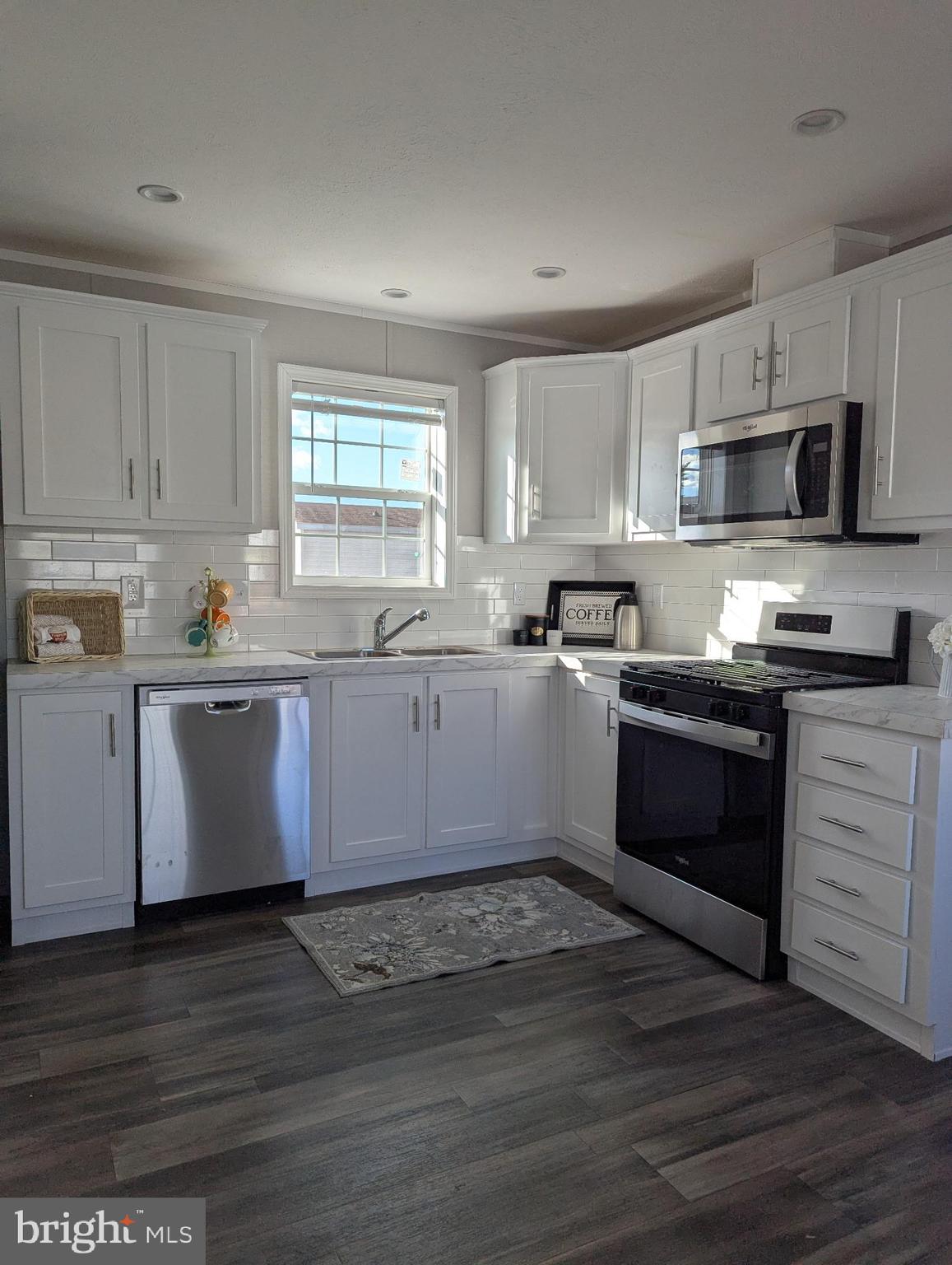 462 Mirabile Lane Baltimore, MD 21224 - Photo 8 of 12 a kitchen with granite countertop a sink cabinets stainless steel appliances and window