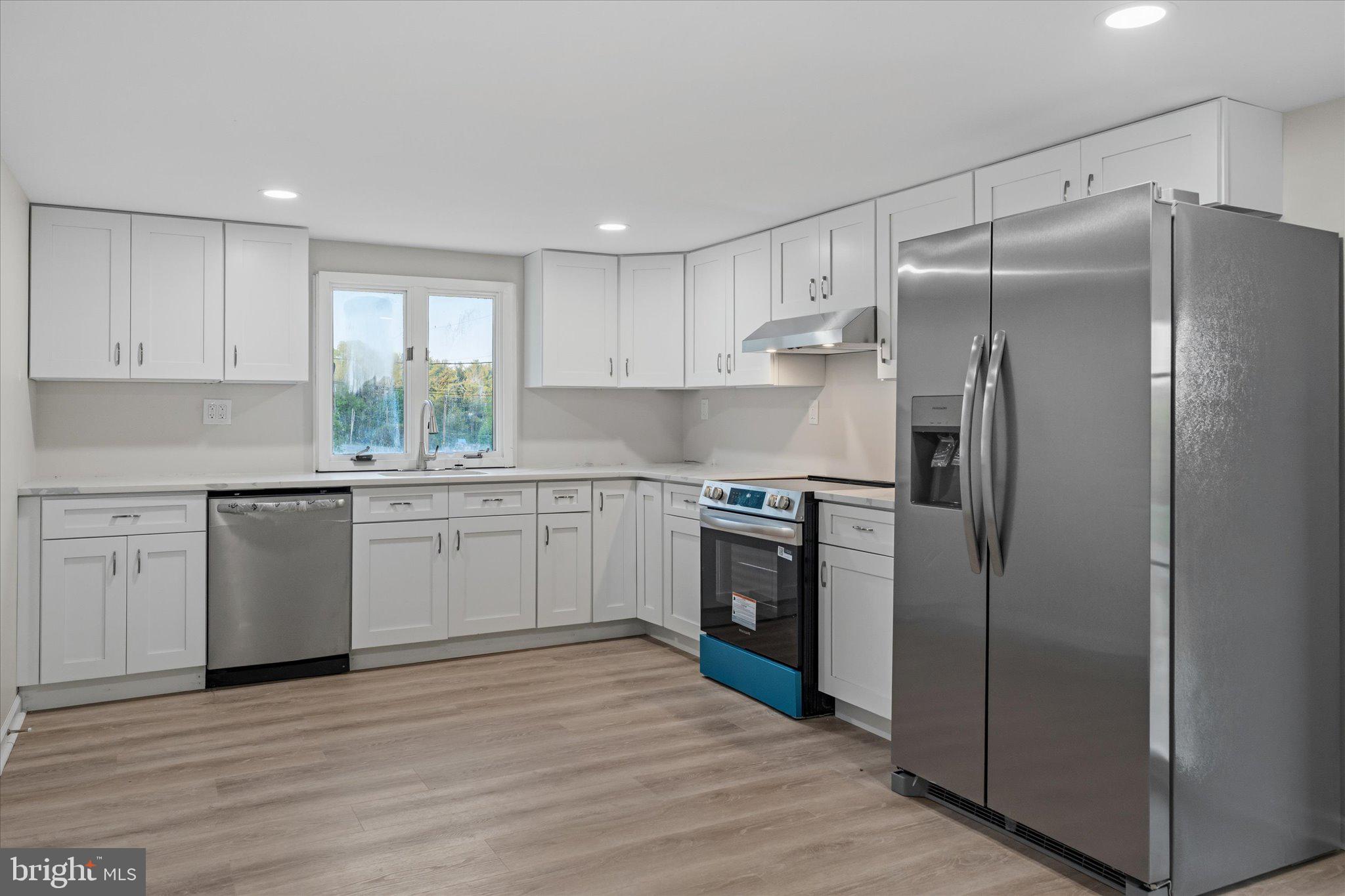 831 Deturksville Road Pine Grove, PA 17963 - Photo 5 of 24 a kitchen with a refrigerator sink and wooden floor