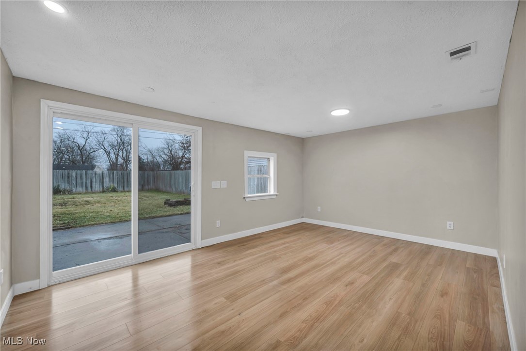 614 Weller Road Elyria, OH 44035 - Photo 17 of 39 Spare room featuring light wood finished floors, a textured ceiling, and recessed lighting