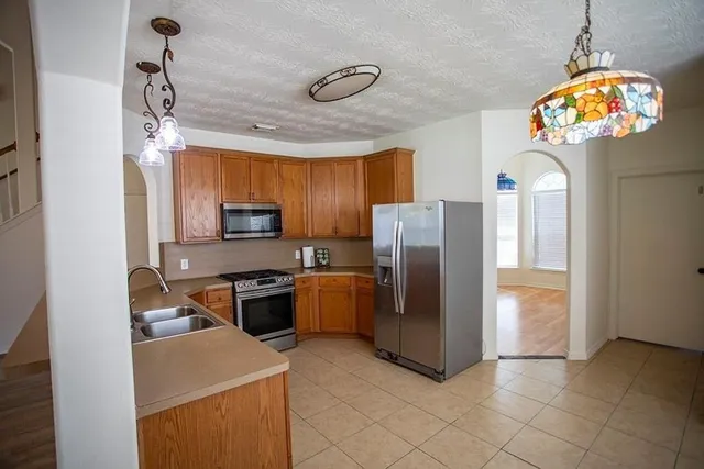 a kitchen with refrigerator and microwave