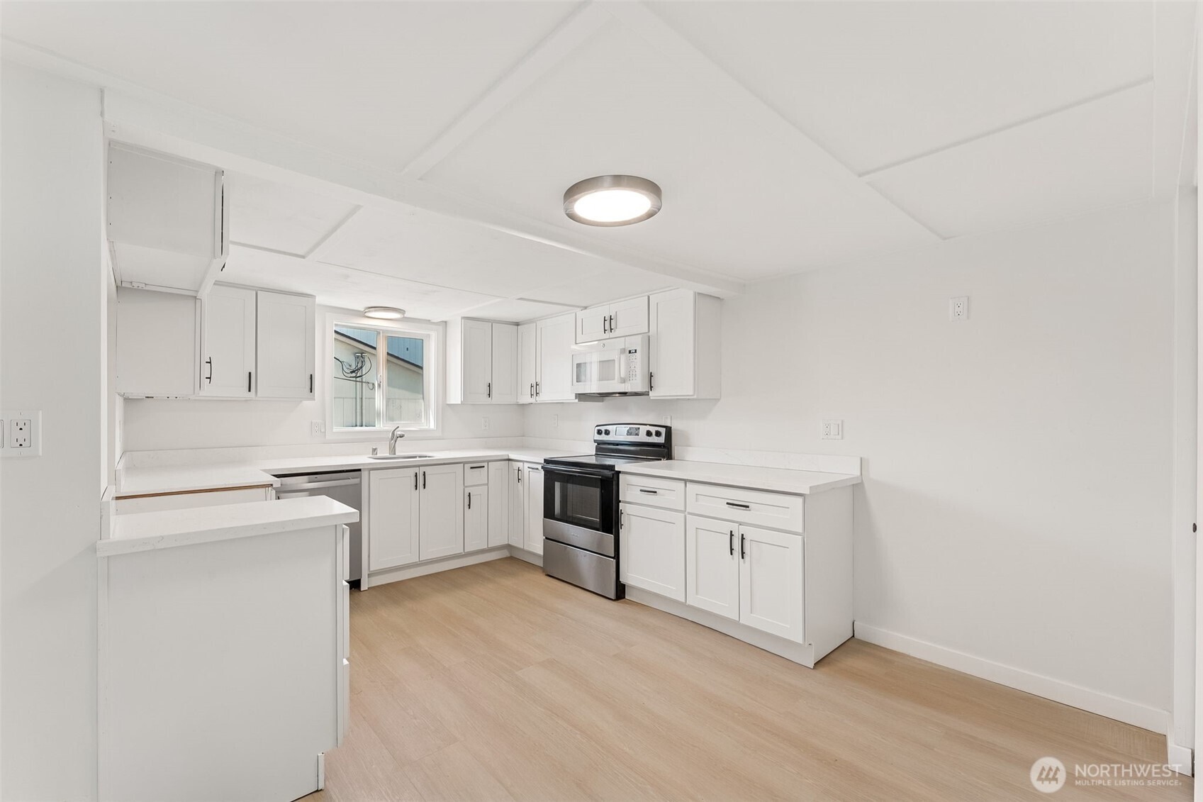 1616 11th Street Bremerton, WA 98337 - Photo 12 of 33 a kitchen with white cabinets and white appliances
