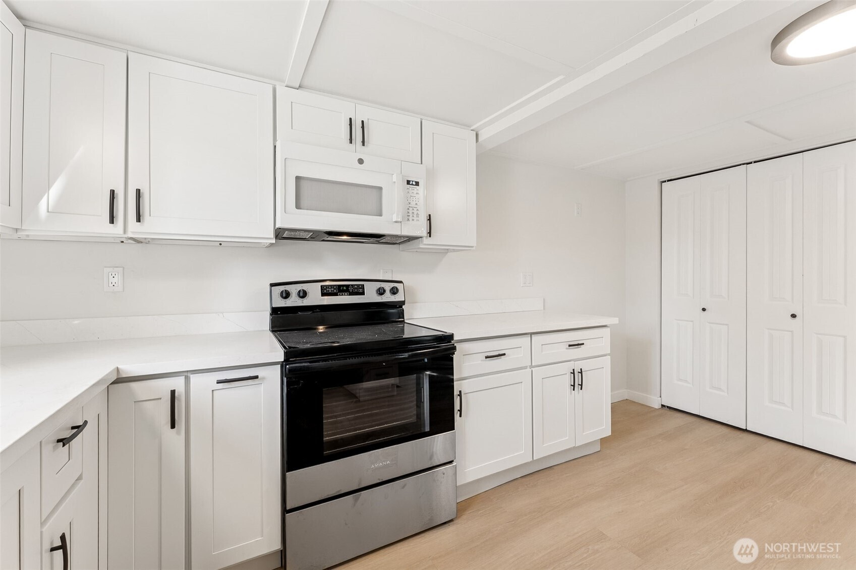 1616 11th Street Bremerton, WA 98337 - Photo 13 of 33 a kitchen with stainless steel appliances white cabinets and a stove top oven