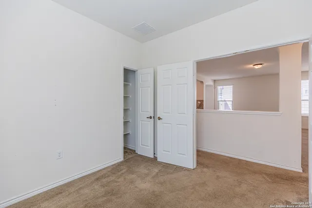 an empty room with mirror in it