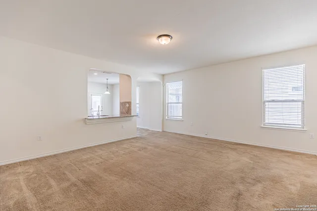 a view of empty room with windows