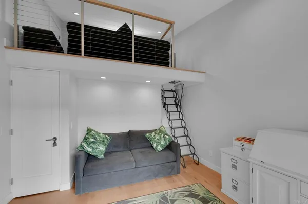 a living room with furniture and a ceiling fan
