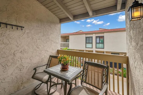 a view of a house with a yard and sitting area