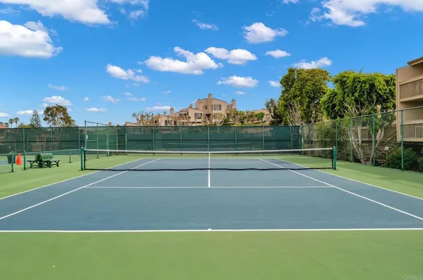 a view of a house with a wooden deck and a floor to ceiling window