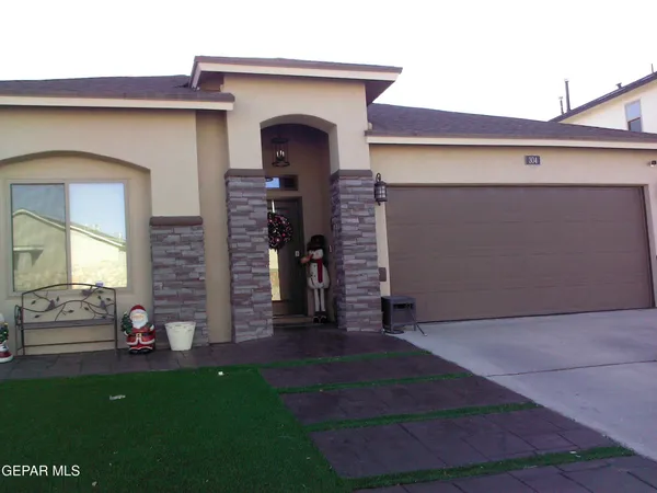 a front view of a house with garage